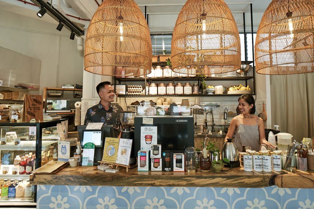 A man and woman behind a cashier counter